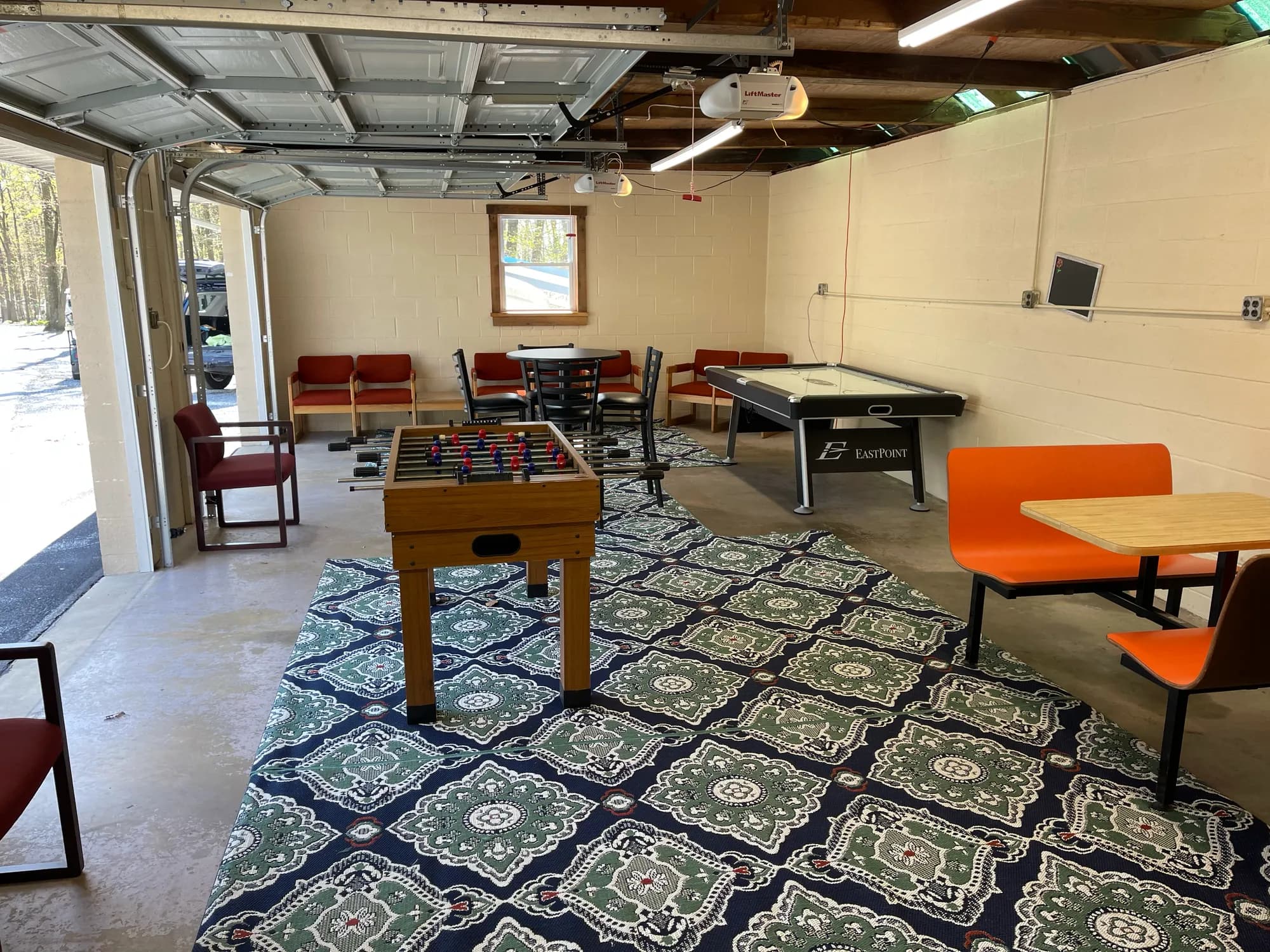Game room with a foosball table, air hockey, and booth seating