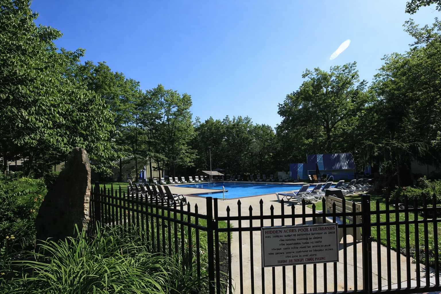 Hidden Acres Campground — pool surrounded by trees