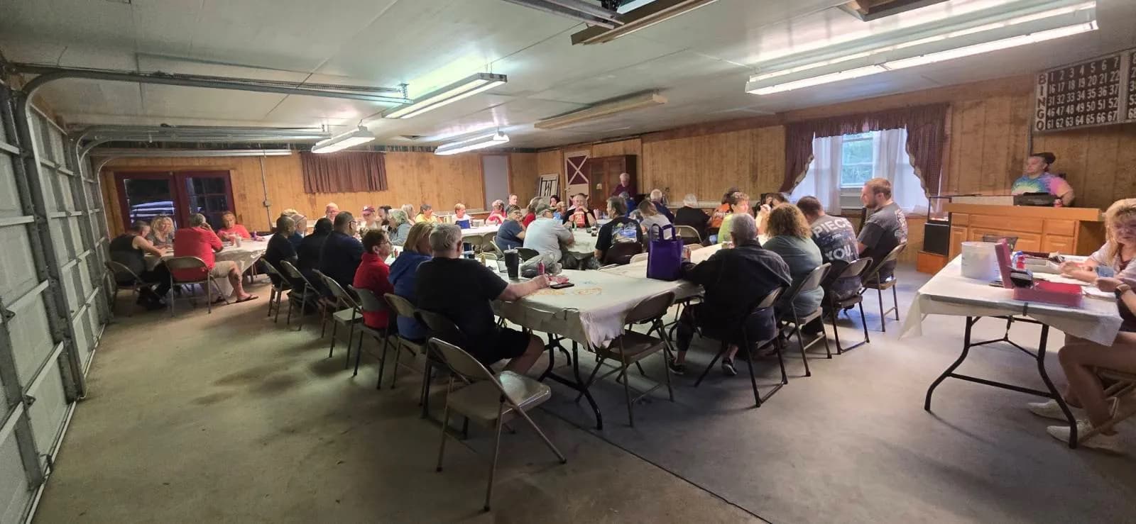 Community bingo night filling the lodge hall with campers at long tables
