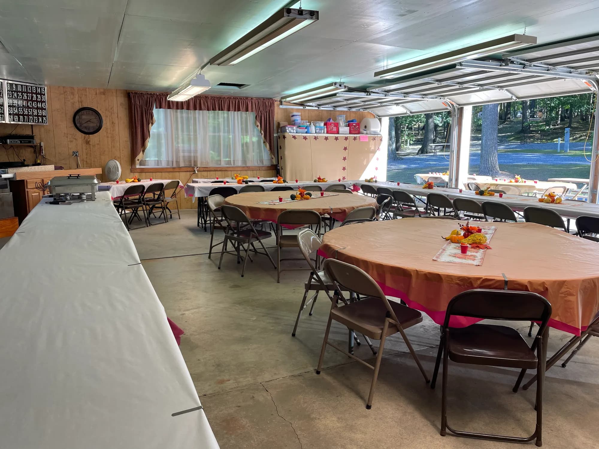 Lodge hall set with round tables and fall centerpieces for an event