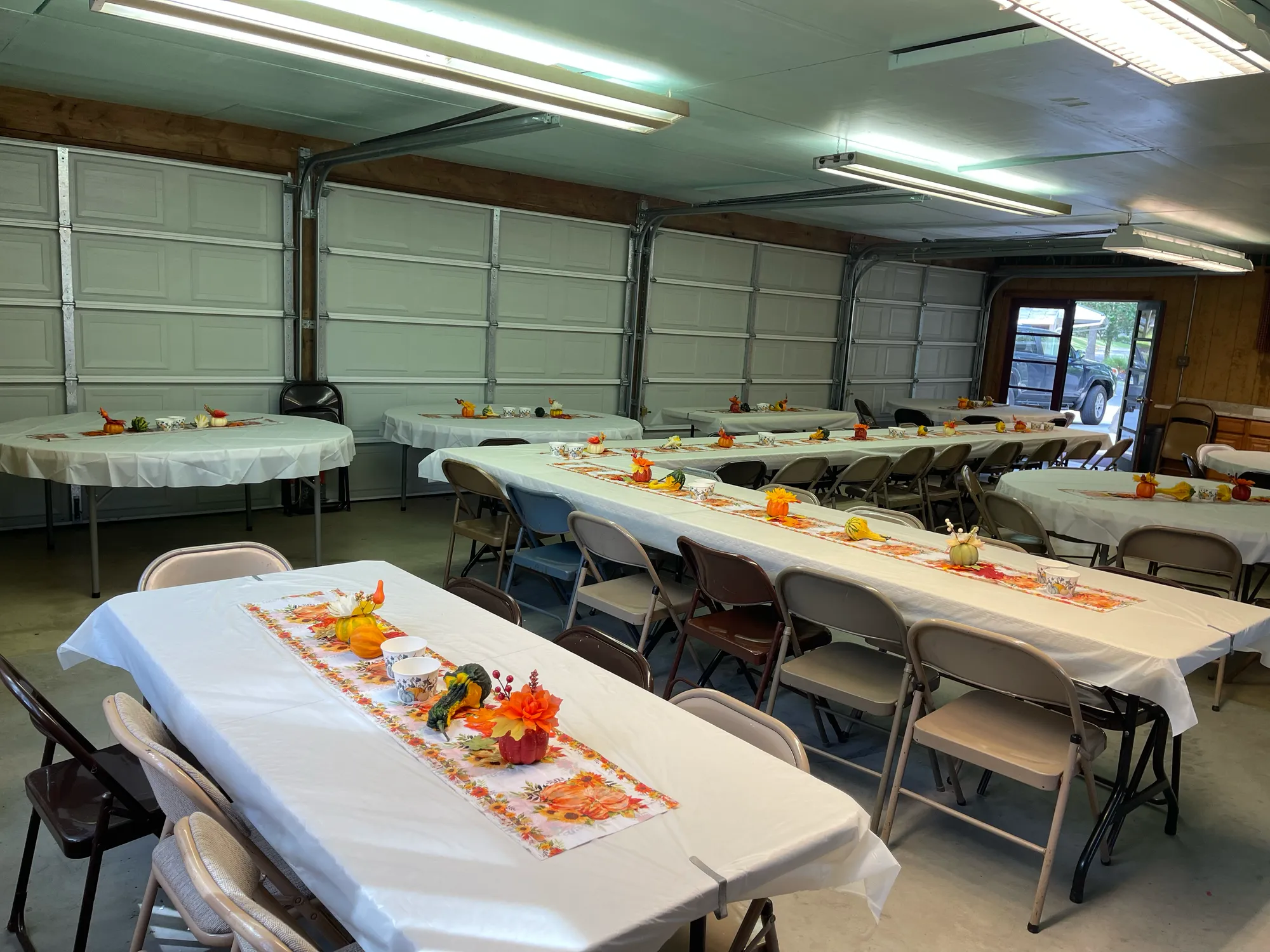 Long tables set with autumn runners and pumpkins in the lodge