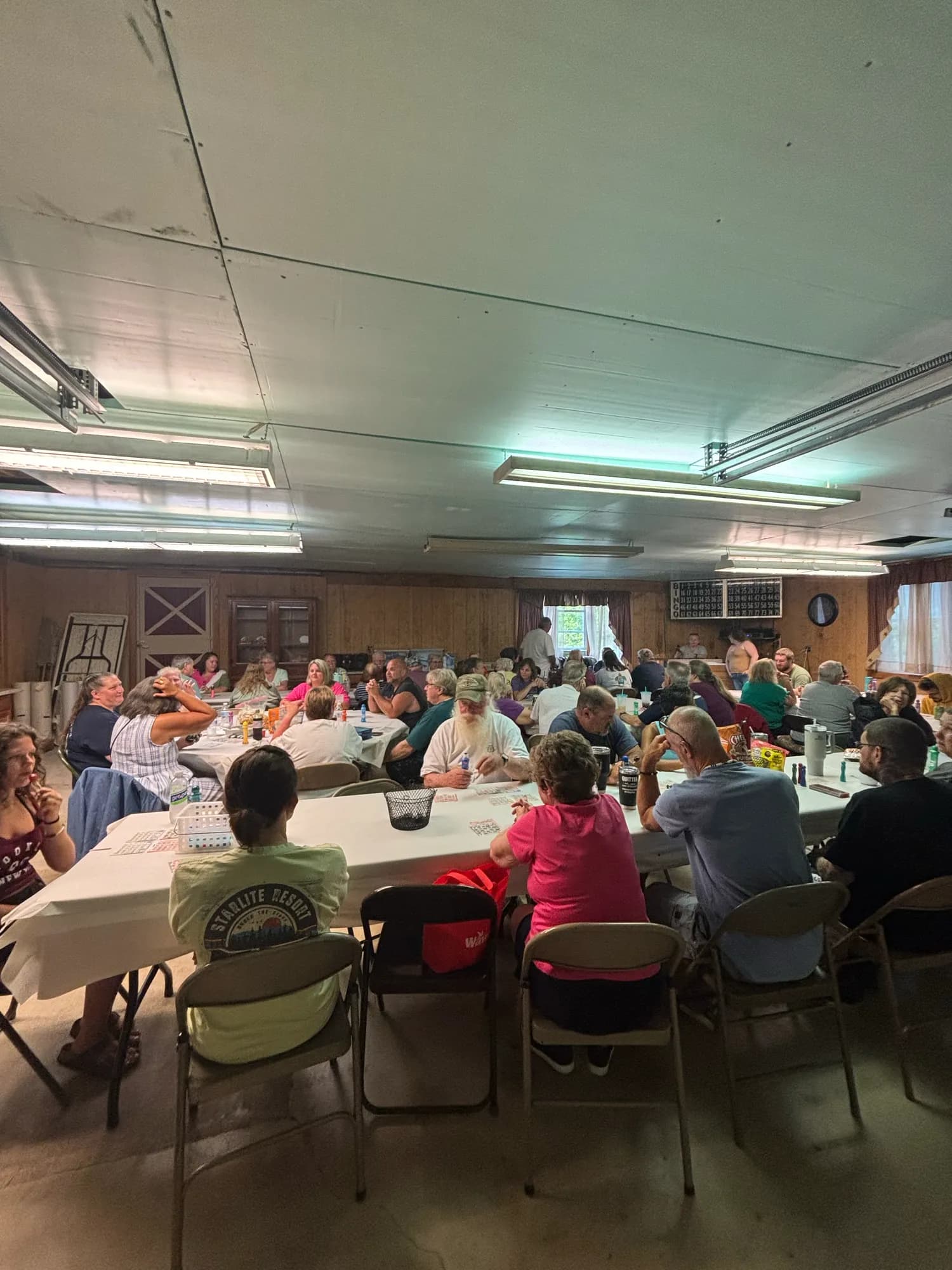 A full lodge hall of campers seated for a community meal
