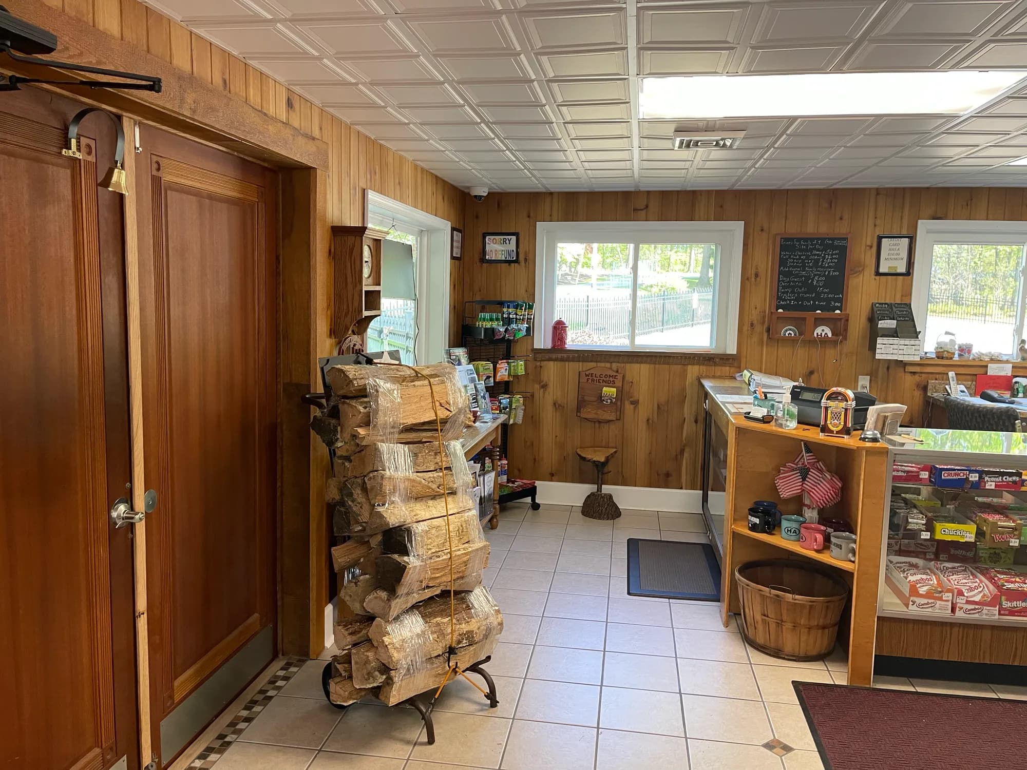 Camp store entrance with bundled firewood and shelves of supplies