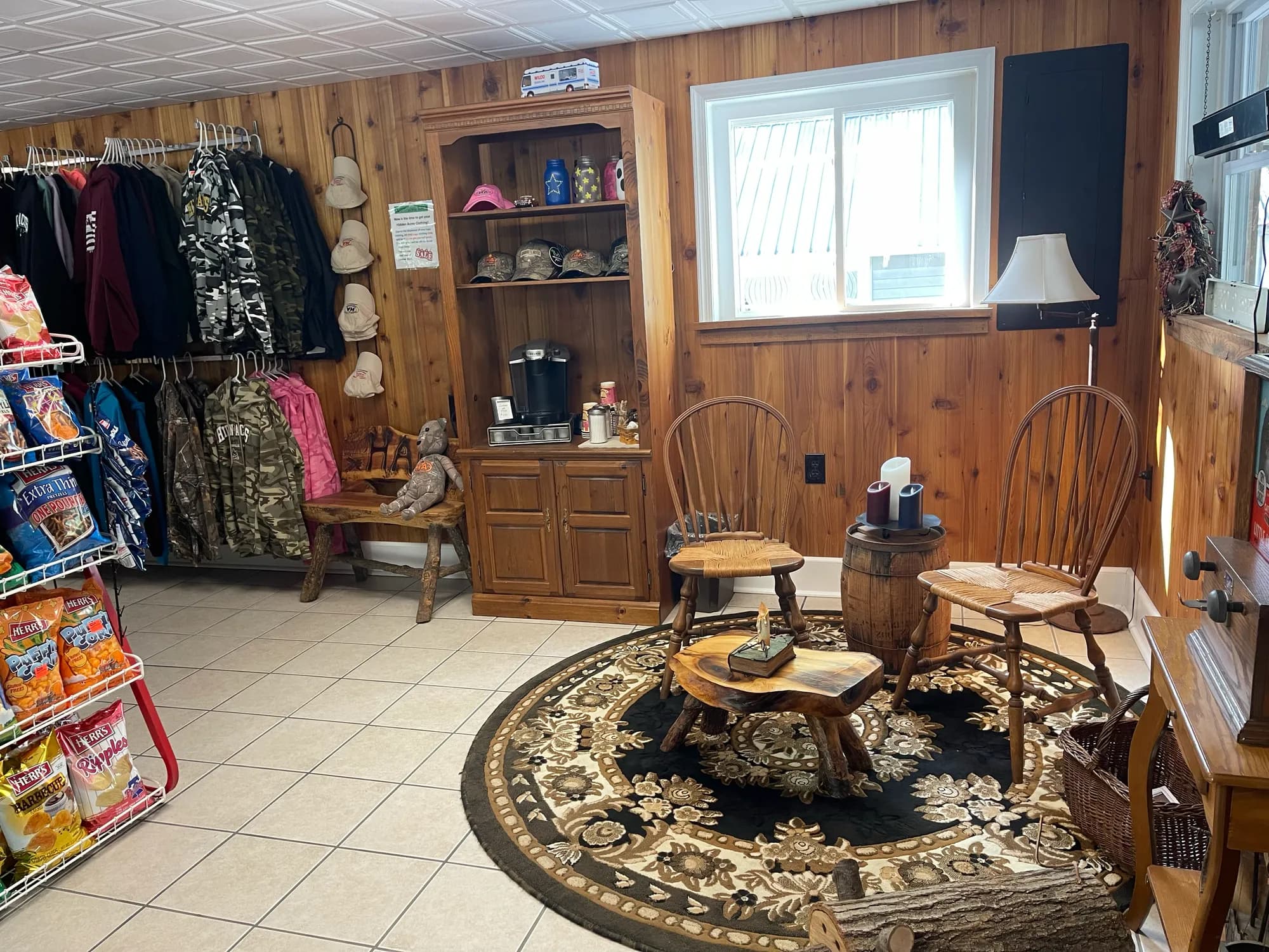 Camp store seating corner with a coffee station and apparel display